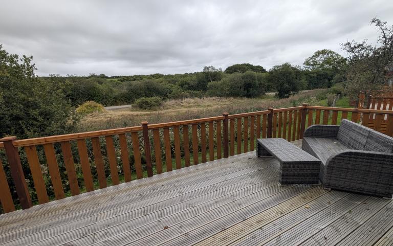 Decking with outside furniture and view of river