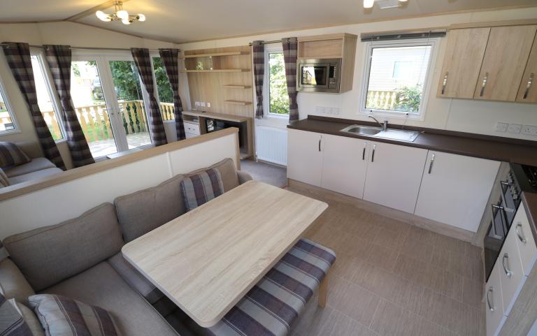 Interior of static caravan with dining table and kitchen