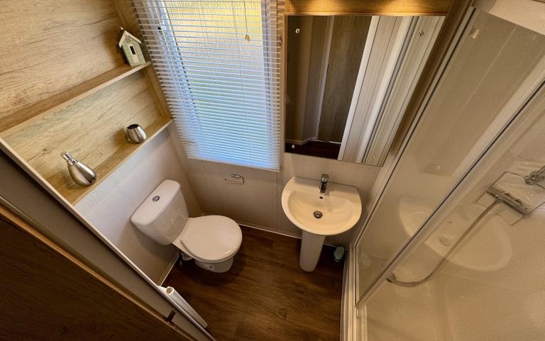 Bathroom with shower, toilet and sink. 