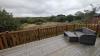 Decking with outside furniture and view of river