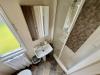 Interior of Bathroom with shower, toilet and sink.