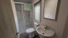 Interior of Bathroom with shower, toilet and sink. 