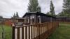 Exterior of a static caravan with a wooden decking.