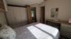 Master bedroom with double bed, in-build wardrobes and a vanity table and stool. 